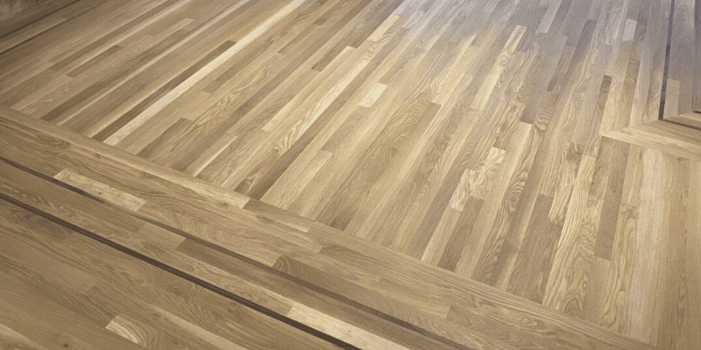 Matte & Satin Finishes 1 Wide-plank matte hardwood floors in a modern Seattle living room, finished by LUKS Construction for a natural, low-sheen, low-maintenance look.