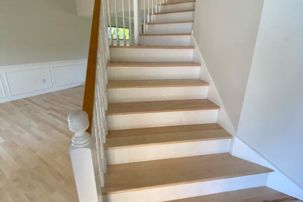 Wooden staircase with white railings