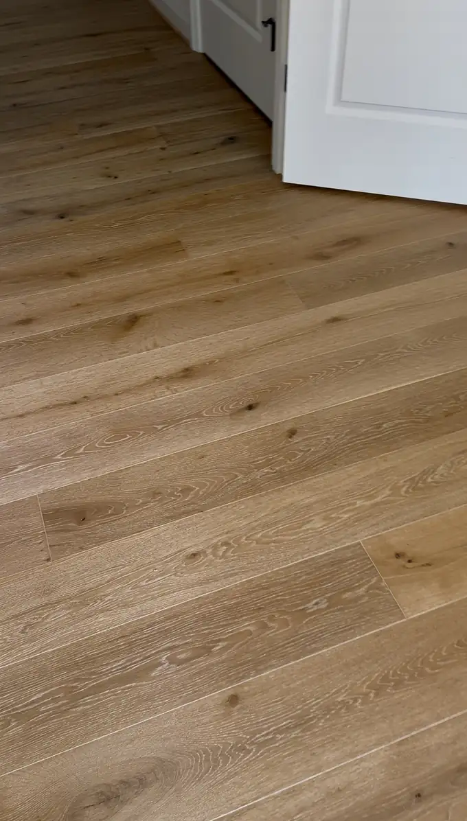 Wire-brushed white oak grain close up at a bedroom doorway