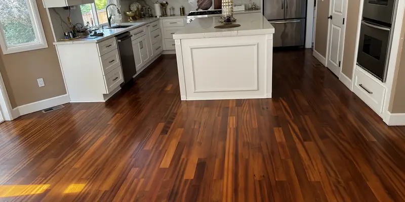 Refinished tatajuba hardwood in an open kitchen with a white island in a Redmond home